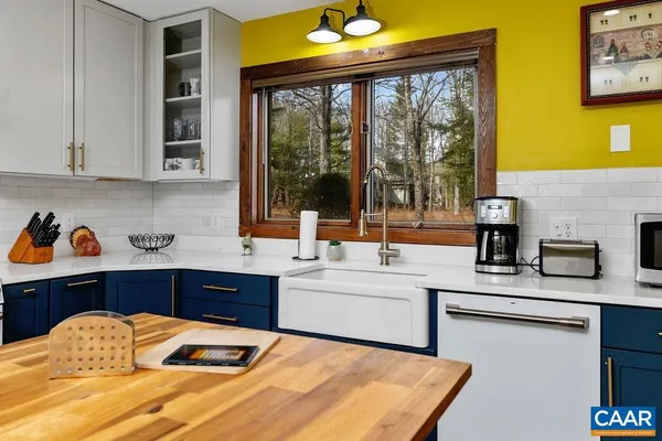 a kitchen with a sink and large window