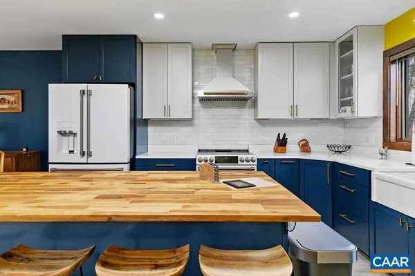 a kitchen with a refrigerator and a stove