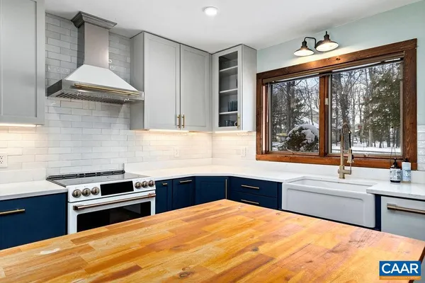 a kitchen with stainless steel appliances granite countertop a stove and a sink