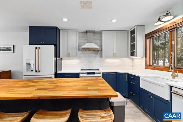 a kitchen with kitchen island a sink table and chairs