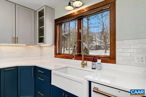 a view of a dining room with furniture a chandelier and wooden floor