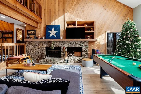 a kitchen with stainless steel appliances granite countertop a sink a stove a refrigerator and island with wooden floor