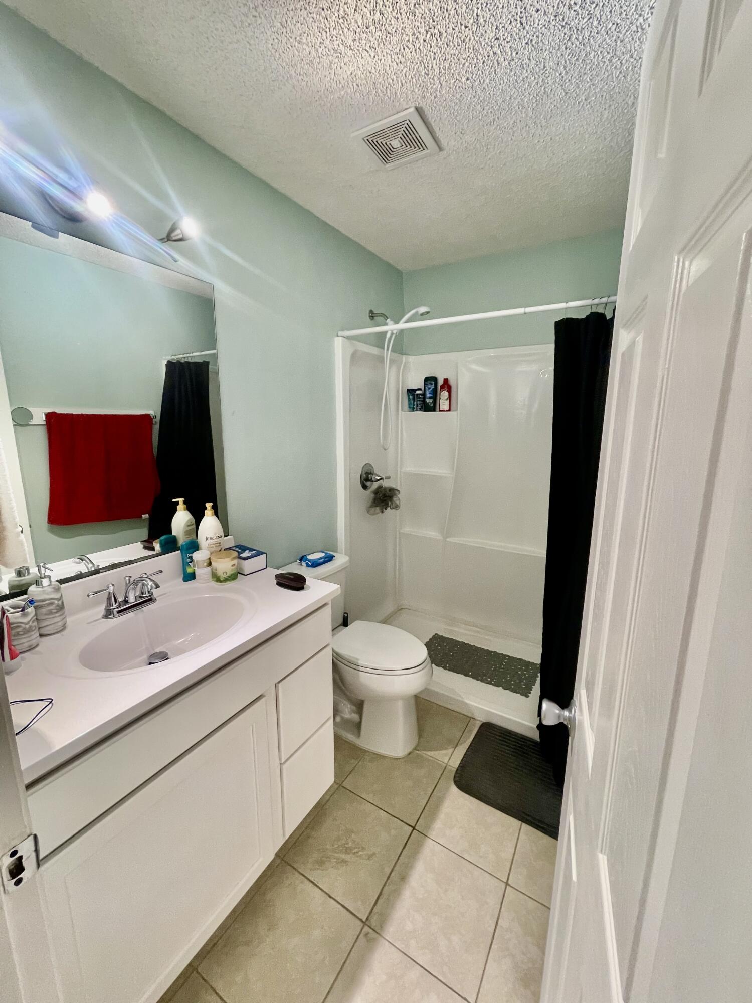 210 Pelham Road, Unit 214A Fort Walton Beach, FL 32547 - Photo 14 of 17 a bathroom with a double vanity sink toilet and shower