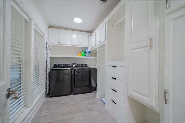 a bathroom with a double vanity sink mirror and shower