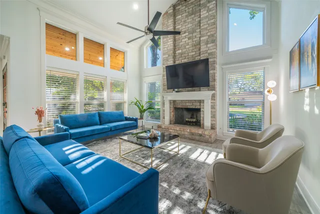 a living room with furniture a flat screen tv and a fireplace