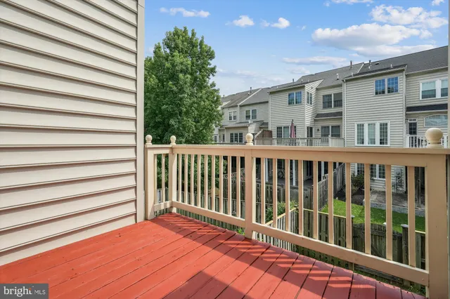 an empty room with a window and a ceiling fan