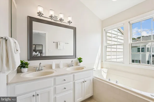 a view of a brick house with a small yard and wooden fence