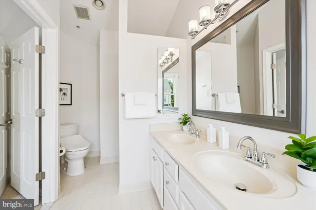 a view of a house with brick walls and a yard with plants