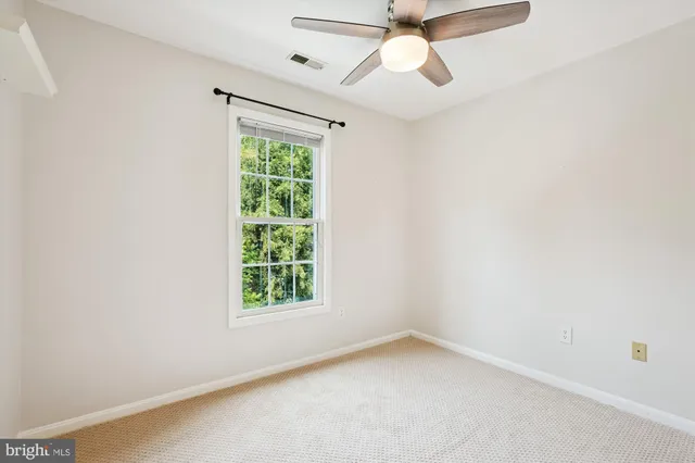 a front view of a building with a garden