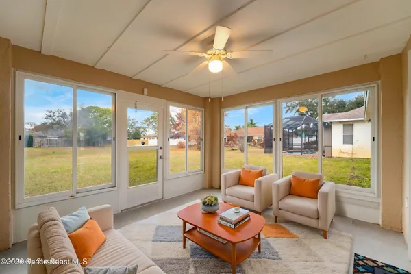 a living room with furniture and a large window