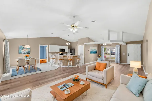 a living room with furniture and a chandelier