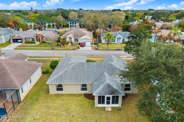 an aerial view of a house with a big yard