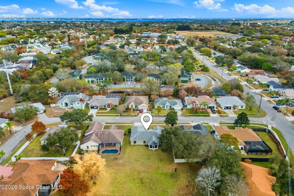 an aerial view of residential houses with outdoor space