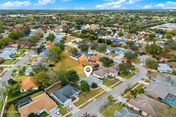 an aerial view of residential houses with outdoor space