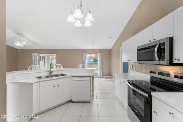 a kitchen with a sink stainless steel appliances and cabinets
