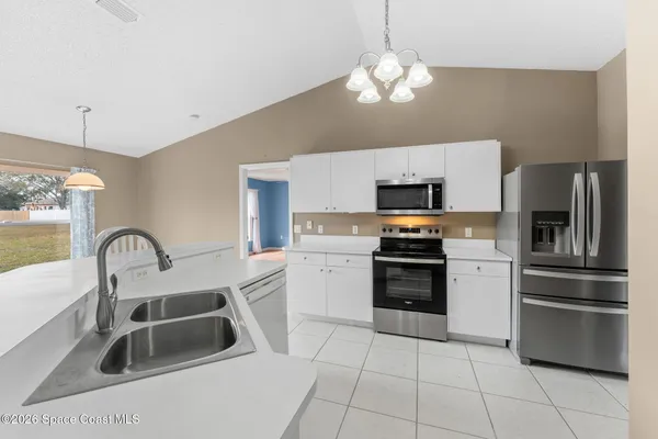 a kitchen with a sink cabinets and stainless steel appliances
