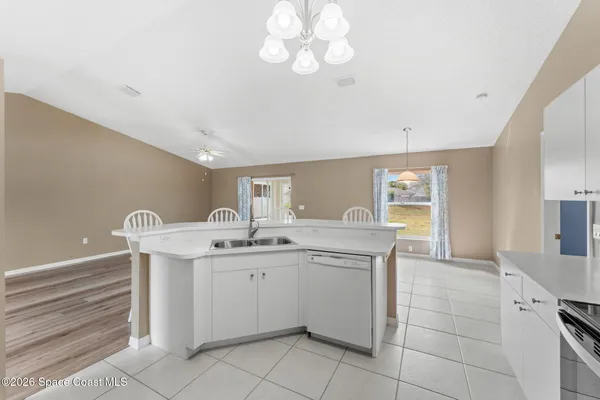 a spacious bathroom with a sink and a mirror