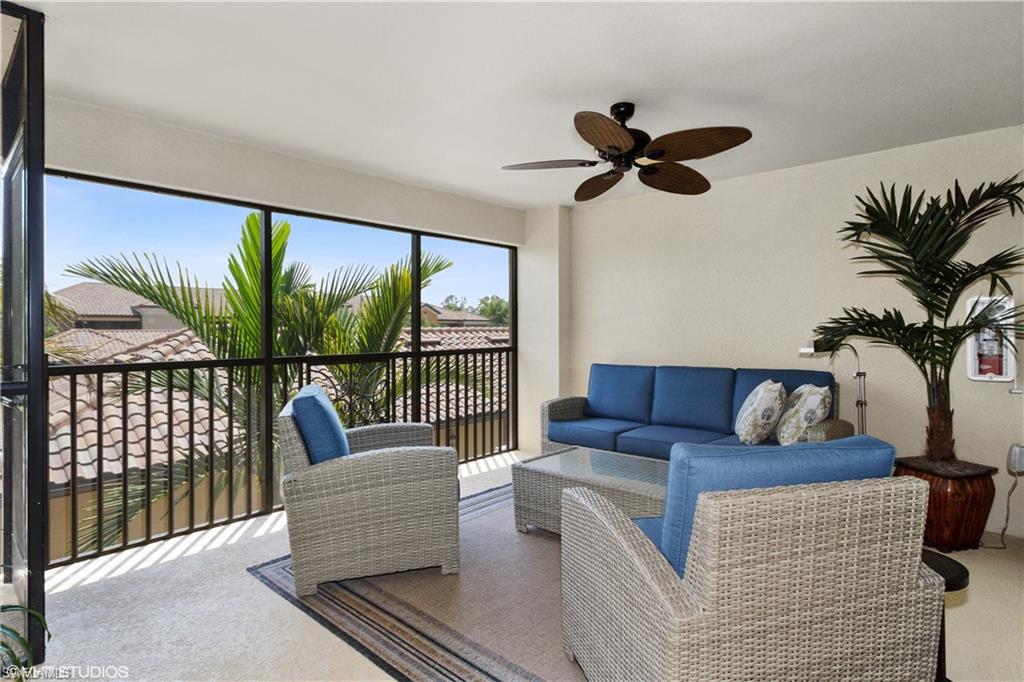 9529 Avellino Way, Unit 2823 Naples, FL 34113 - Photo 15 of 25 a living room with furniture and a floor to ceiling window