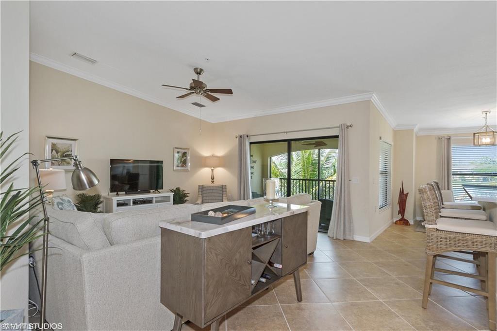 9529 Avellino Way, Unit 2823 Naples, FL 34113 - Photo 3 of 25 a kitchen that has a sink a counter top space appliances and a center island