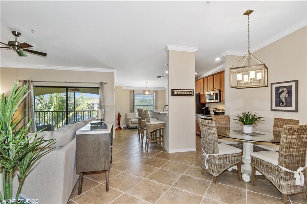 9529 Avellino Way, Unit 2823 Naples, FL 34113 - Photo 5 of 25 a living room with furniture a window and appliances
