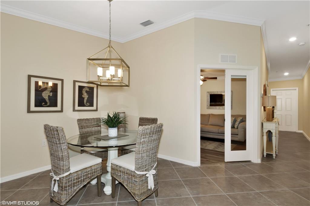 9529 Avellino Way, Unit 2823 Naples, FL 34113 - Photo 9 of 25 a dining room with furniture and window