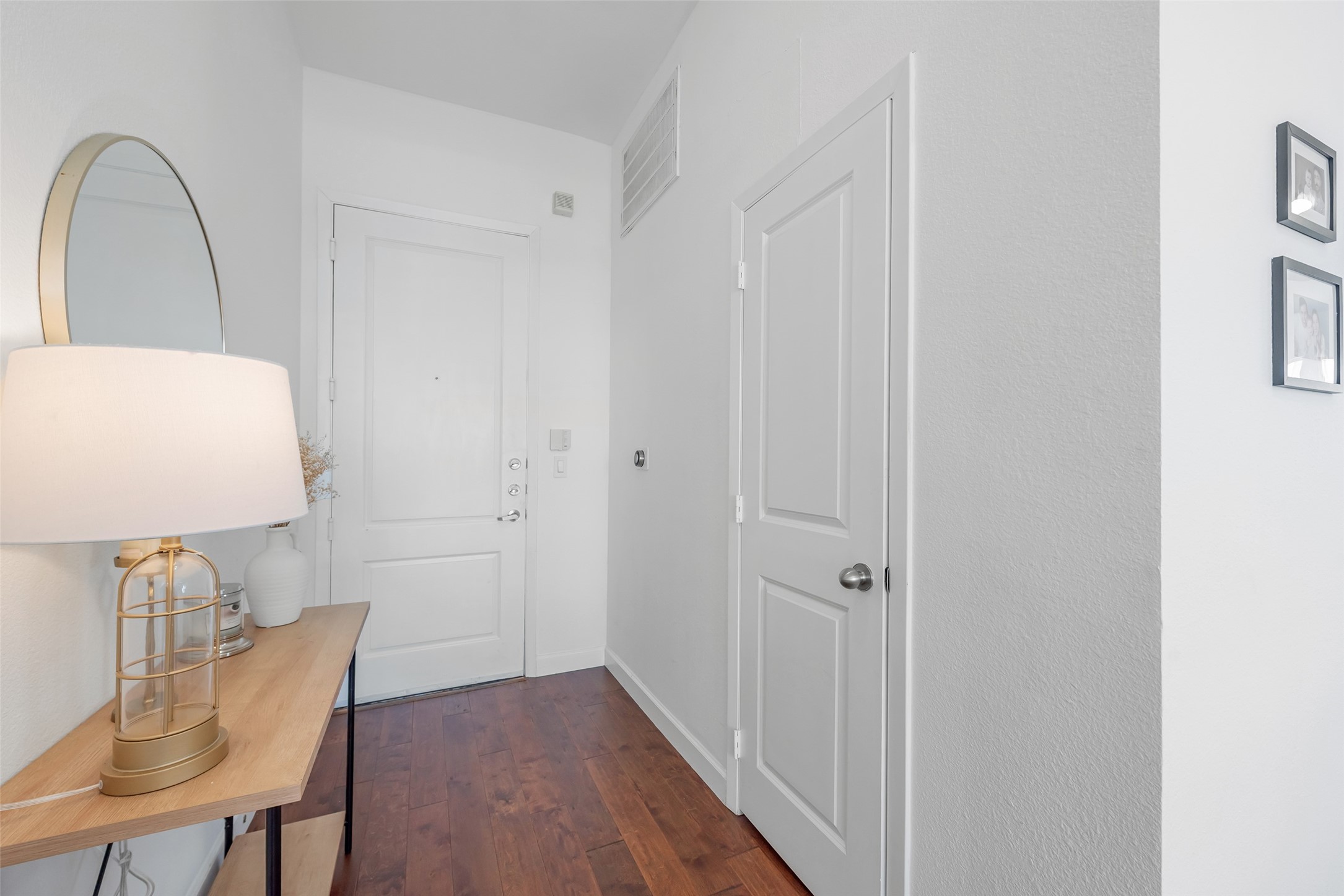 3505 Sage Road, Unit 2210 Houston, TX 77056 - Photo 6 of 40 An entryway with rich hardwood floors, complemented by a spacious coat closet conveniently located to the right lead you into this beautiful unit that was recently painted.