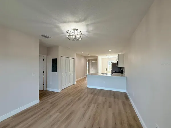 a view of a room with wooden floor