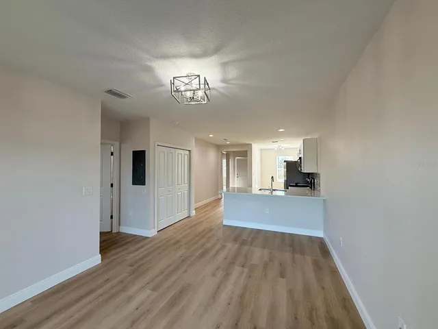 a view of a room with wooden floor