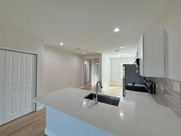 a view of a room with wooden floor