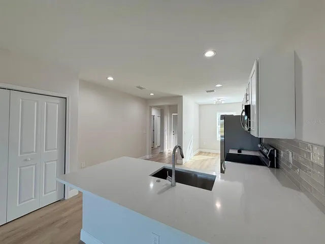 a view of a room with wooden floor
