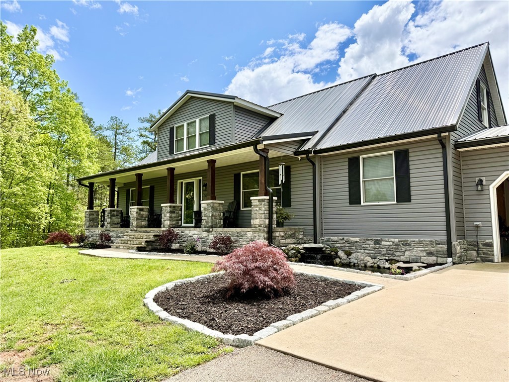 399 Wilder Road Vinton, OH 45686 - Photo 1 of 36 View of front of property with stone siding, covered porch, a front lawn, and concrete driveway