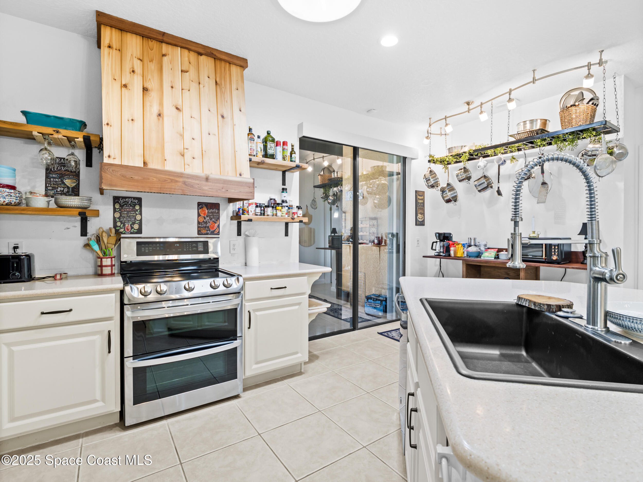 1214 Bolle Circle Rockledge, FL 32955 - Photo 11 of 27 a kitchen with stainless steel appliances granite countertop a sink and a stove