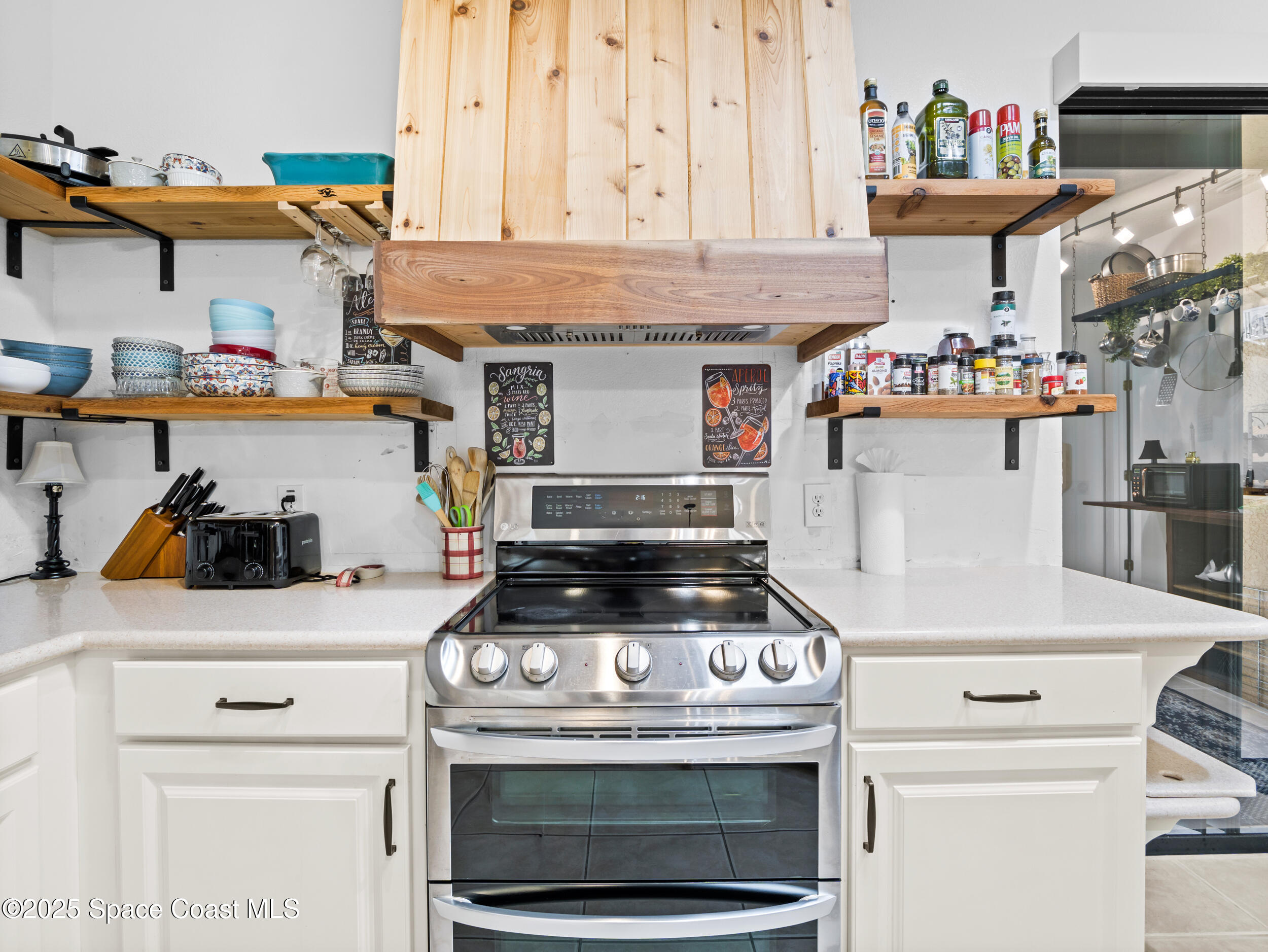 1214 Bolle Circle Rockledge, FL 32955 - Photo 12 of 27 a kitchen with a stove and cabinets