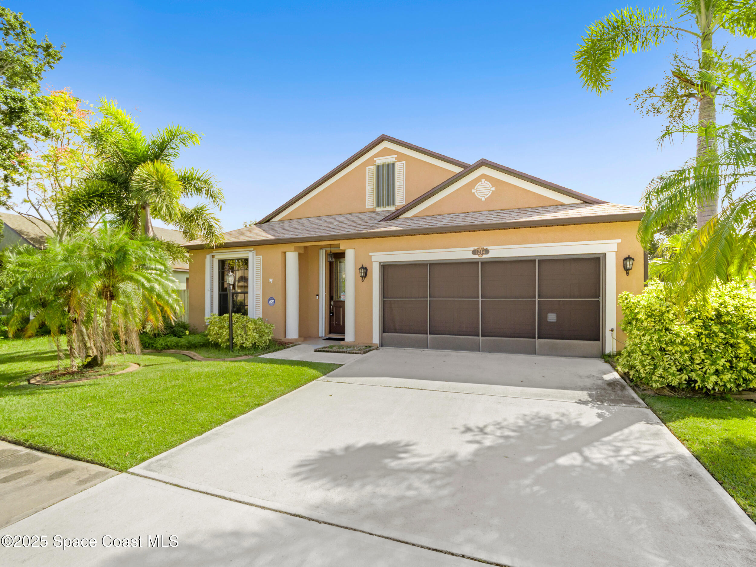 1214 Bolle Circle Rockledge, FL 32955 - Photo 2 of 27 a front view of a house with a garden and yard