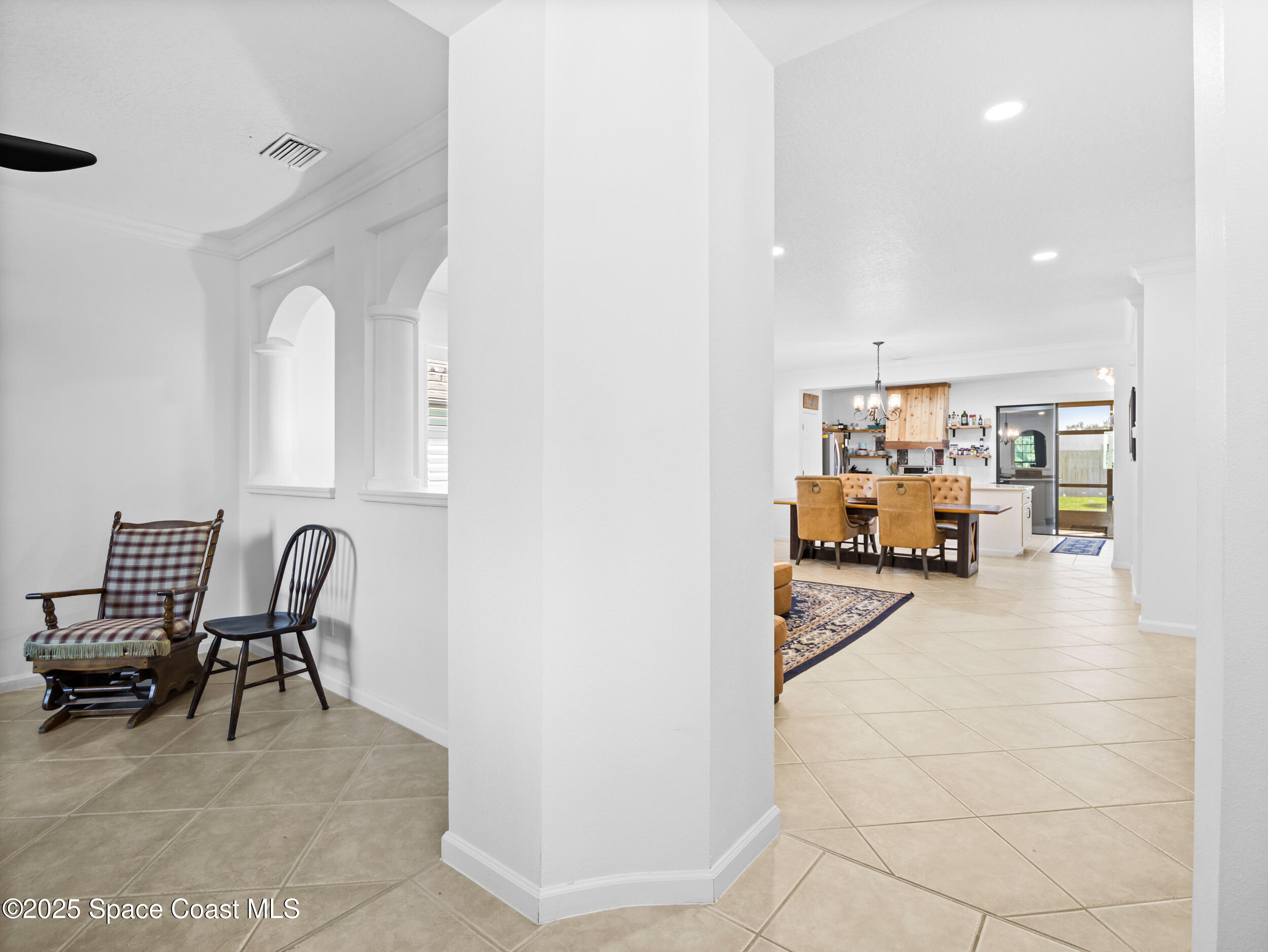 1214 Bolle Circle Rockledge, FL 32955 - Photo 3 of 27 a dining room with furniture and a chandelier