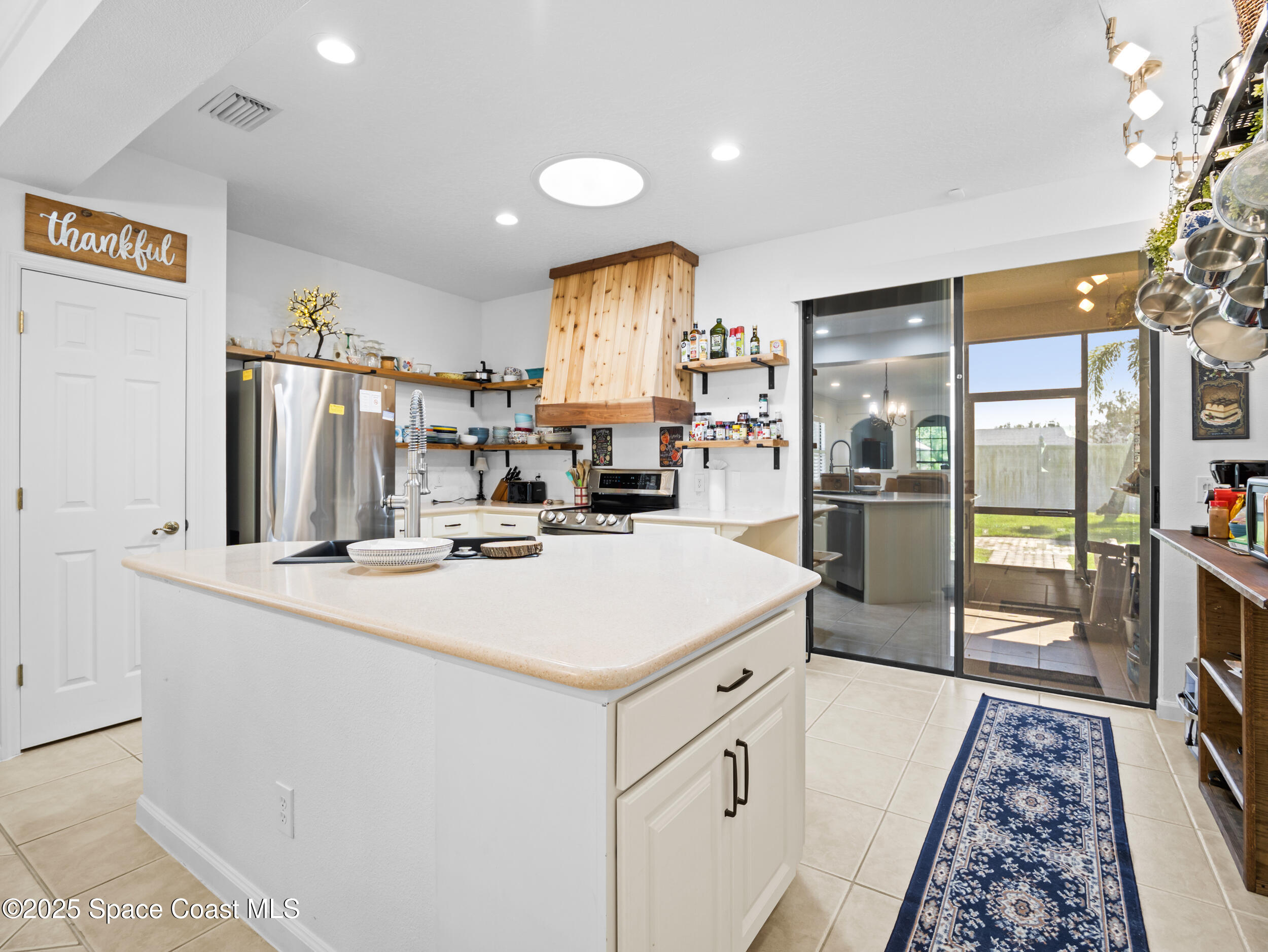 1214 Bolle Circle Rockledge, FL 32955 - Photo 10 of 27 a kitchen with stainless steel appliances a refrigerator sink and cabinets