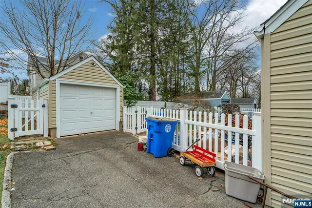 a view of a wooden house with a large trees