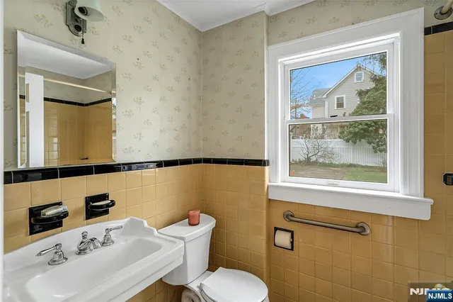 a bathroom with a sink mirror and toilet