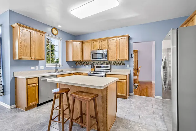 a kitchen with stainless steel appliances granite countertop a stove refrigerator sink and dishwasher