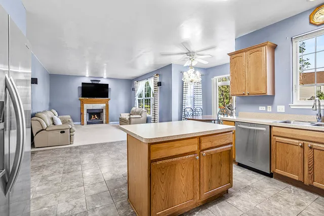 a view of kitchen with sink microwave and refrigerator