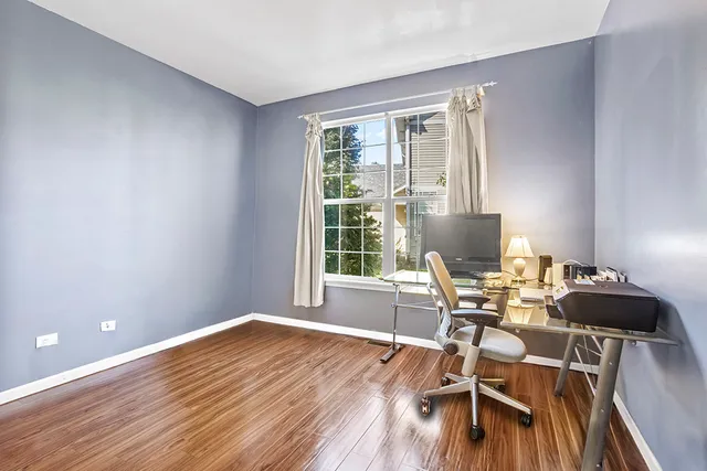 a workspace with furniture hardwood and a window
