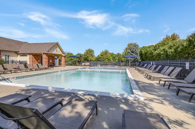 a view of swimming pool with outdoor seating and plants