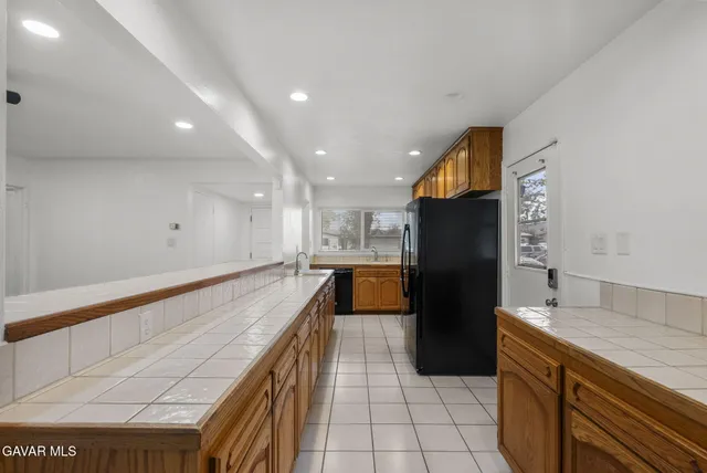 a kitchen with a refrigerator and a sink