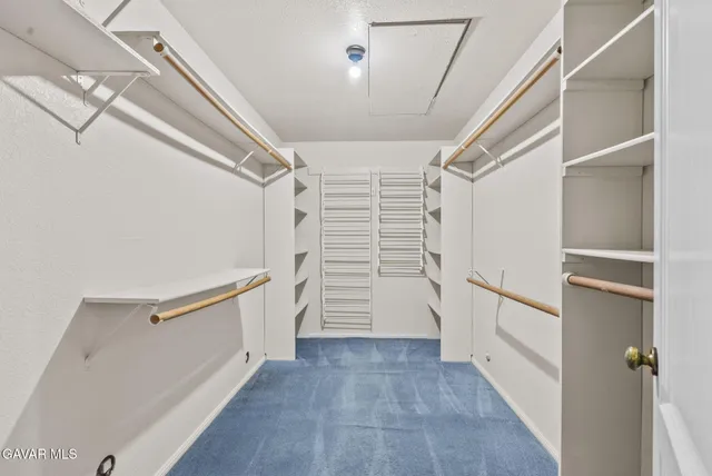 a view of walk in closet with stairs