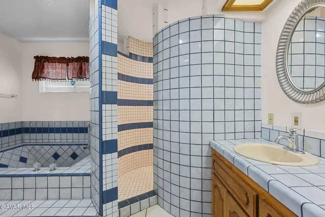 a bathroom with a sink a bathtub and shower