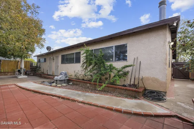 a backyard of a house with yard and outdoor seating