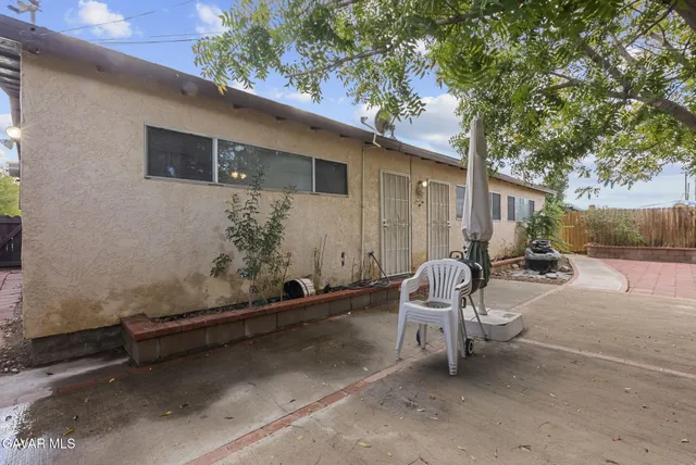a view of backyard with outdoor seating and stairs