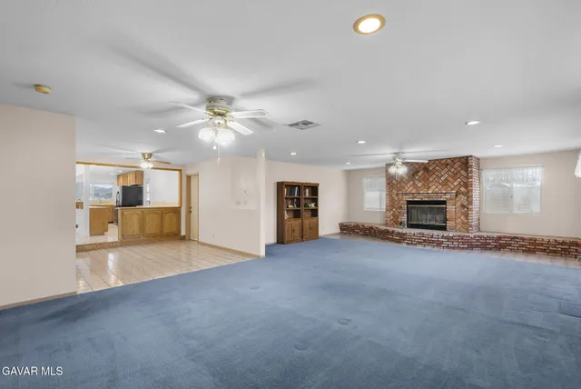a view of an empty room with a fireplace