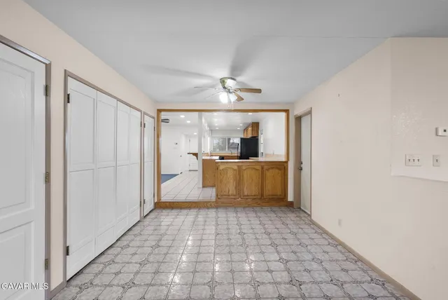 a view of a kitchen with a sink and a refrigerator
