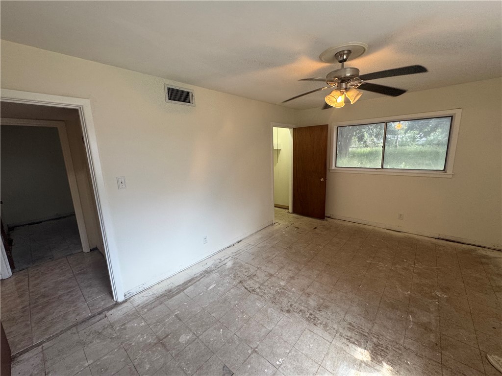 409 Taylor Road Falfurrias, TX 78355 - Photo 13 of 13 an empty room with windows and fan